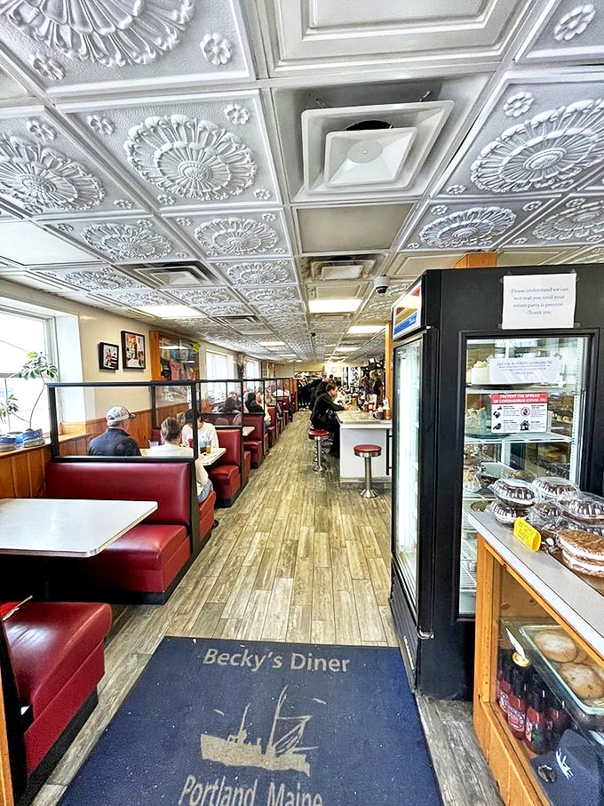 Those ornate tin ceiling tiles and cozy red booths tell you everything: This isn't just a diner, it's a slice of preserved Americana. Photo credit: Pa T.