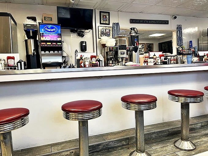 Classic chrome counter stools line up like soldiers, ready for the next wave of hungry diners seeking comfort food paradise. Photo credit: Carrie C.