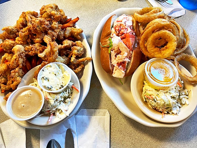 Double the deliciousness: Golden-fried clams and a classic lobster roll share the spotlight with crispy onion rings and fresh coleslaw. Photo credit: JD H.