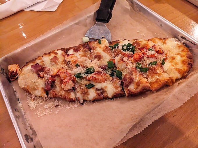 This flatbread is a canvas of culinary creativity, topped with seafood and fresh herbs that tell a delicious coastal story. Photo credit: Daniel 