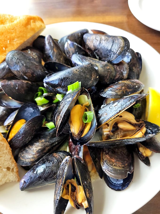 Fresh mussels steamed to perfection, each one a tiny treasure chest of briny goodness waiting to be discovered. Photo credit: Amy Dunlea