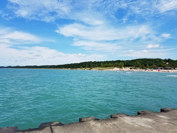 Pentwater: Where Lake Michigan whispers sweet nothings. This picturesque pier invites you to stroll into a perfect sunset.