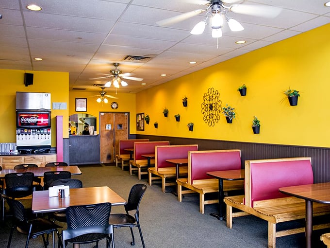 Yellow walls, red booths, and a rainbow of flavors. Mancino's is like stepping into a pizza-powered time machine set to 'delicious.' Photo credit: Mancino's Pizza & Grinders