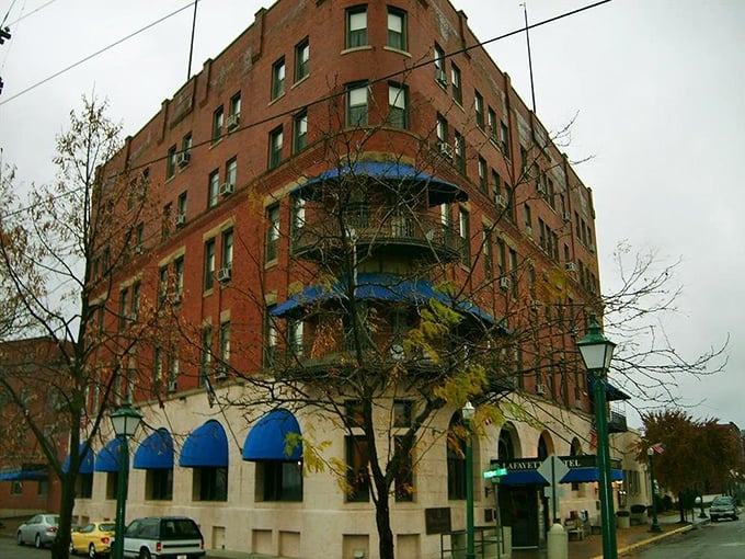 Riverboat chic meets ghostly mystique! The Lafayette Hotel's grand facade hides secrets older than your grandpa's jokes.