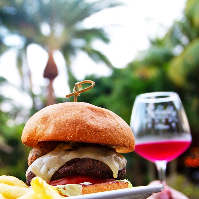 Burger bliss in paradise. Who says you can't pair a juicy burger with tropical fruit wine? Rules are meant to be deliciously broken.