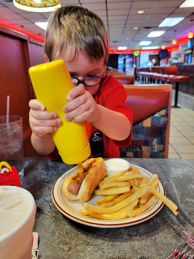 Ketchup and mustard art worthy of MoMA! This little guy's about to embark on a flavor adventure.