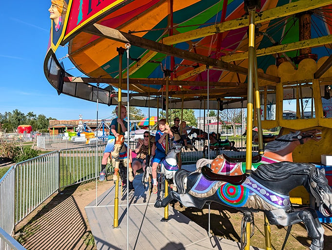 Round and round we go on this merry menagerie! The carousel's a whirl of color that'll make you dizzy with delight.