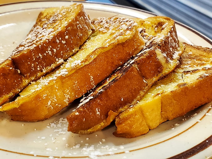 French toast so golden and crispy, it could make the Mona Lisa crack a smile. Dusted with powdered sugar, it's the breakfast equivalent of a warm hug from your favorite aunt.