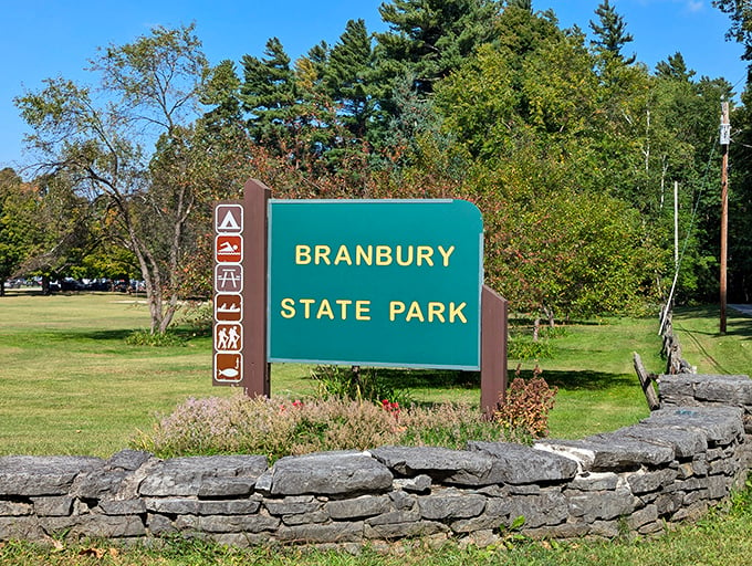 Welcome to Branbury State Park, where the sign promises adventure and the stone wall whispers tales of Vermont's rugged charm.