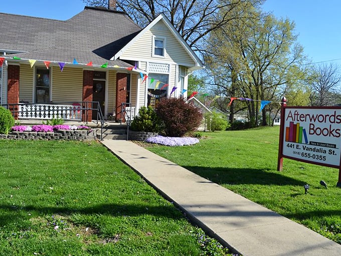 Festive flags and vibrant flowers welcome bibliophiles. It's like a year-round literary carnival minus the cotton candy! Photo credit: Afterwords Books