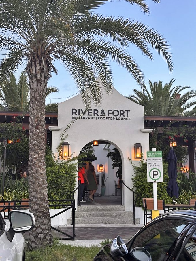 Welcome to River & Fort, where palm trees whisper secrets of culinary delights! This charming entrance is like a portal to flavor paradise. Photo credit: Garry R.