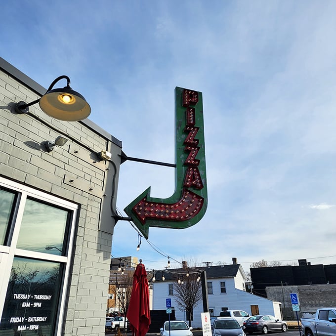 A slice of neon heaven! This retro sign isn't just pointing the way to pizza—it's guiding you to your new happy place.