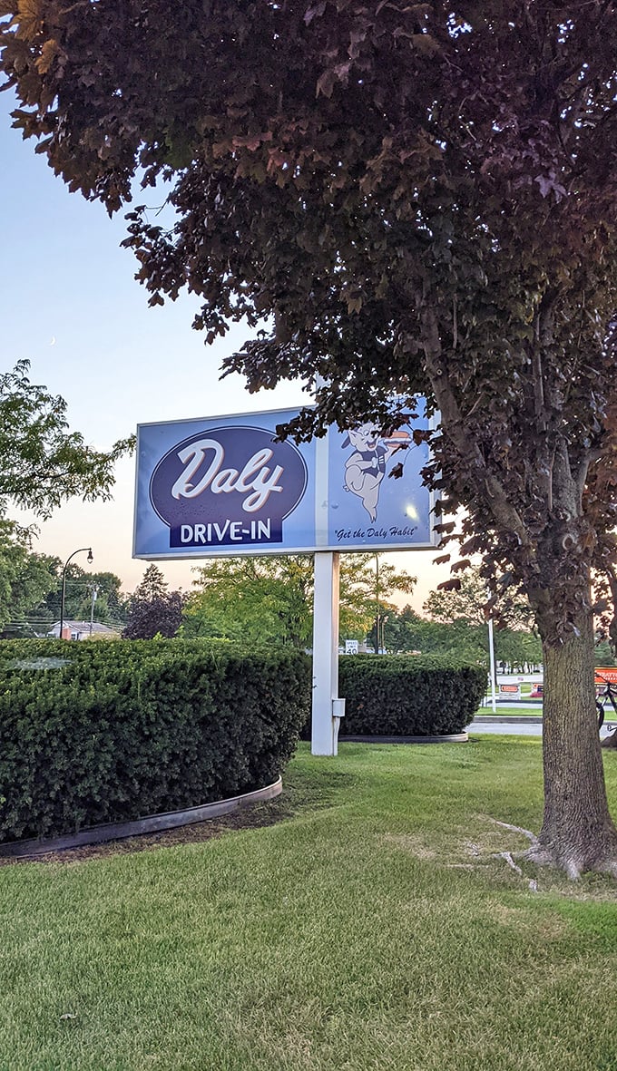 "Step right up, folks!" This sign isn't just an invitation; it's a time machine disguised as neon and nostalgia. Welcome to Daly Drive-In, where the 1950s never ended!