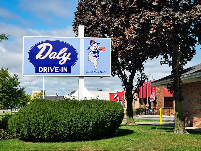 "Step right up, folks!" This sign isn't just an invitation; it's a time machine disguised as neon and nostalgia. Welcome to Daly Drive-In, where the 1950s never ended!